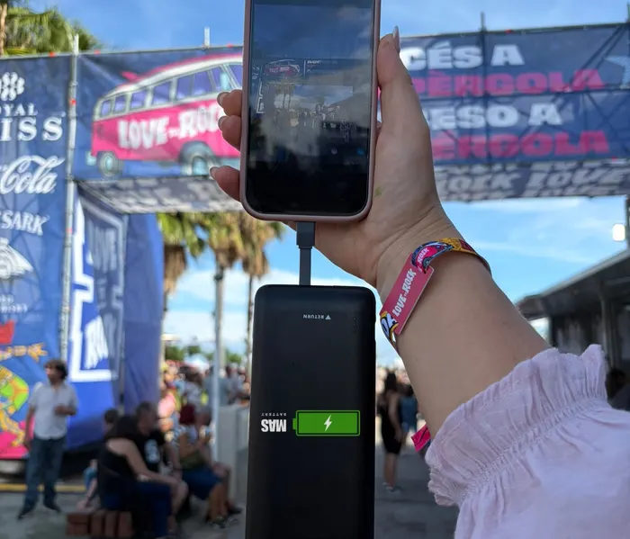A MasBattery power bank charging a phone at Love to Rock 2026